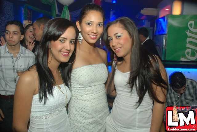 three women in short dresses standing next to each other