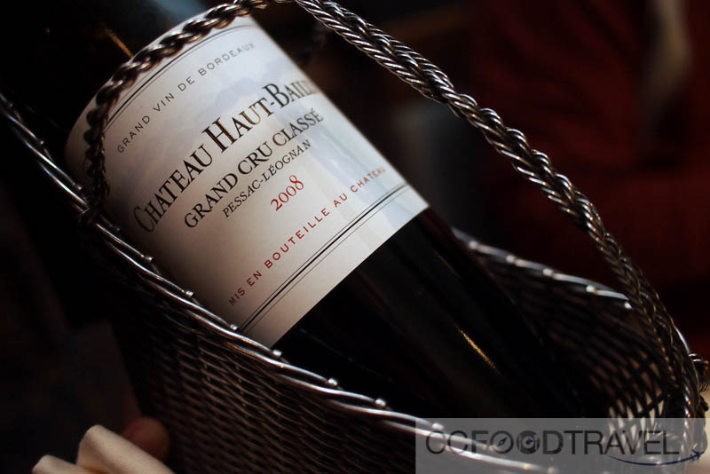 a bottle of wine sitting in a wire basket