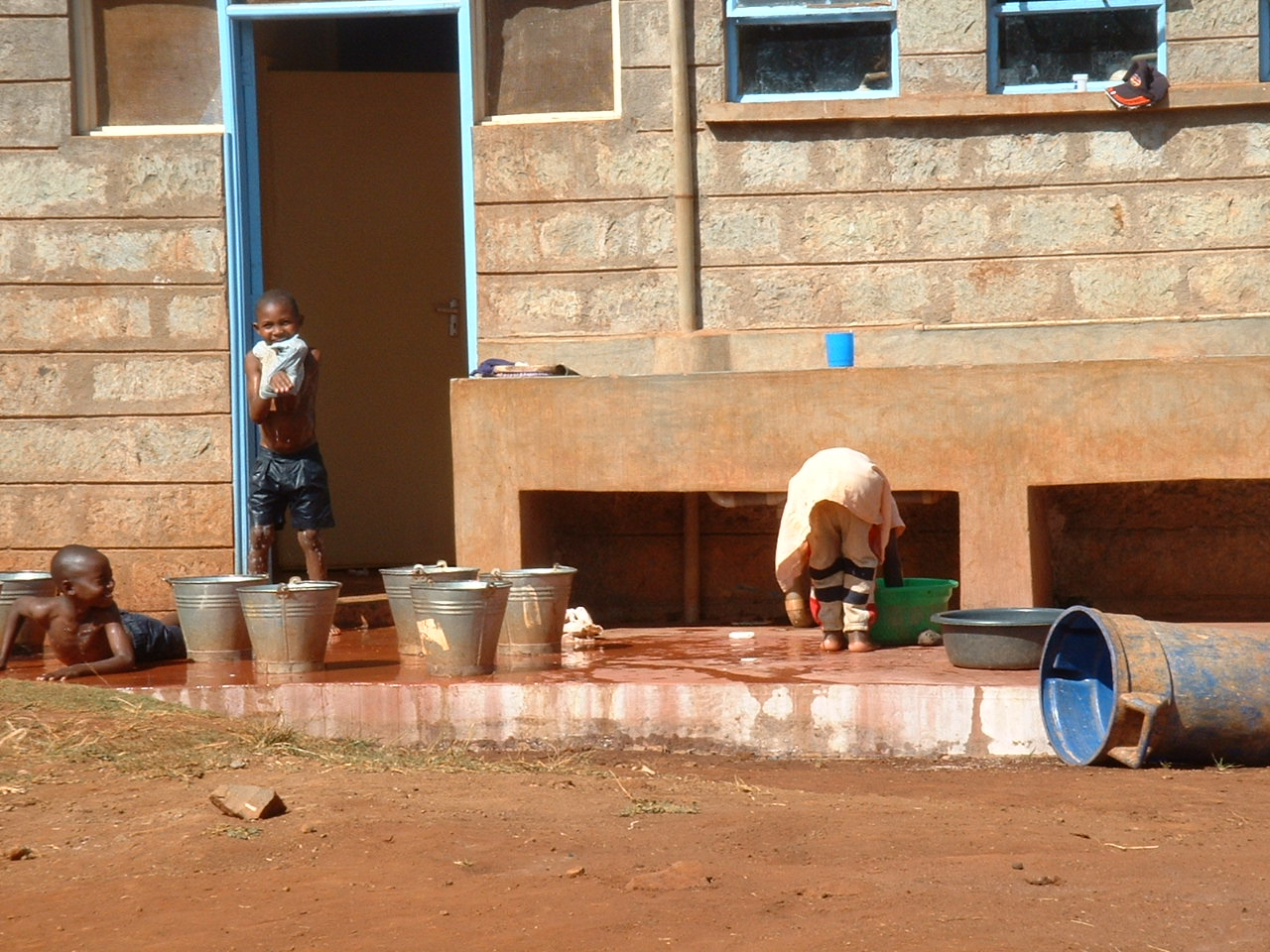 a  standing next to buckets of water