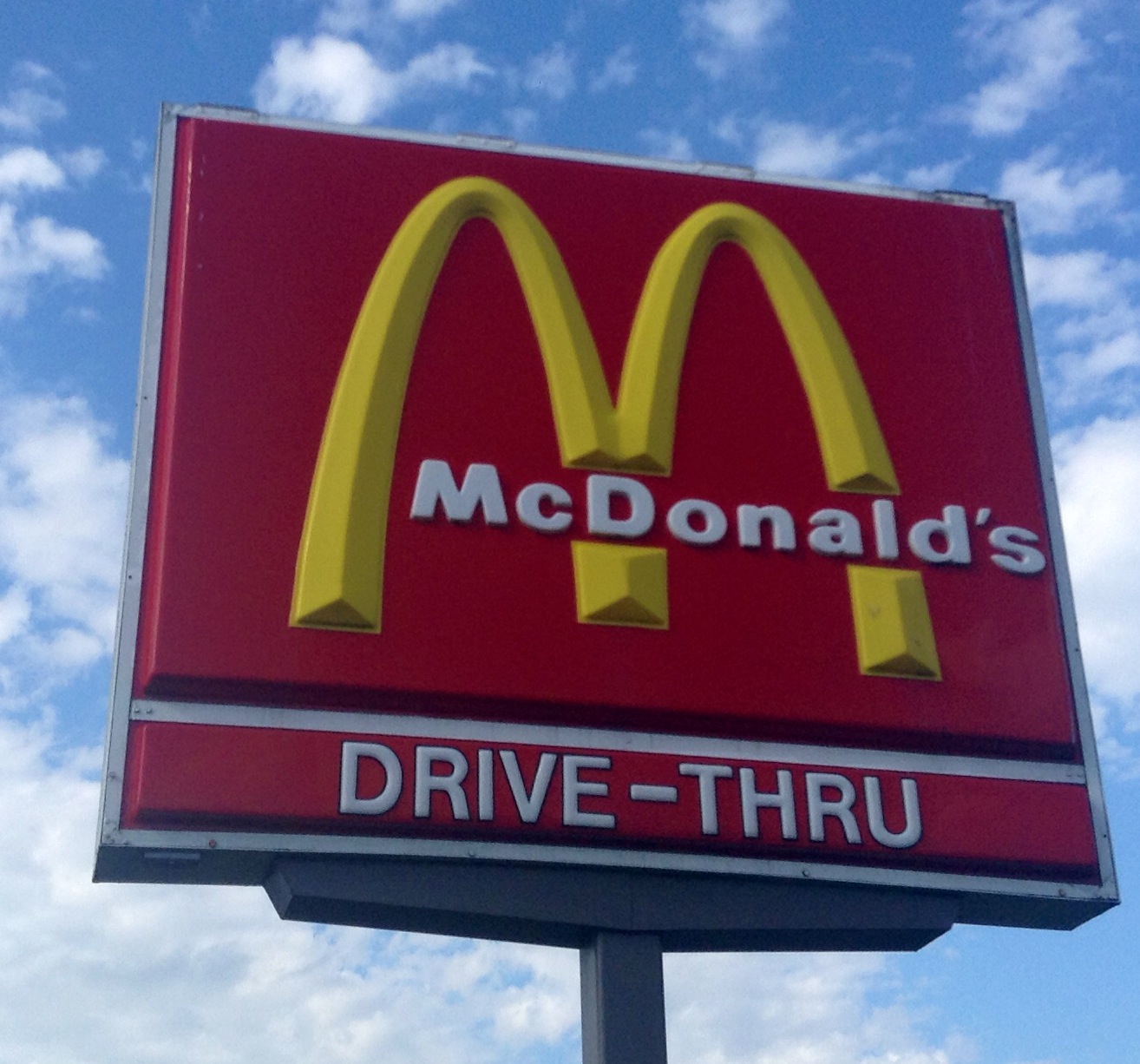 the sign for the mcdonalds drive thru restaurant