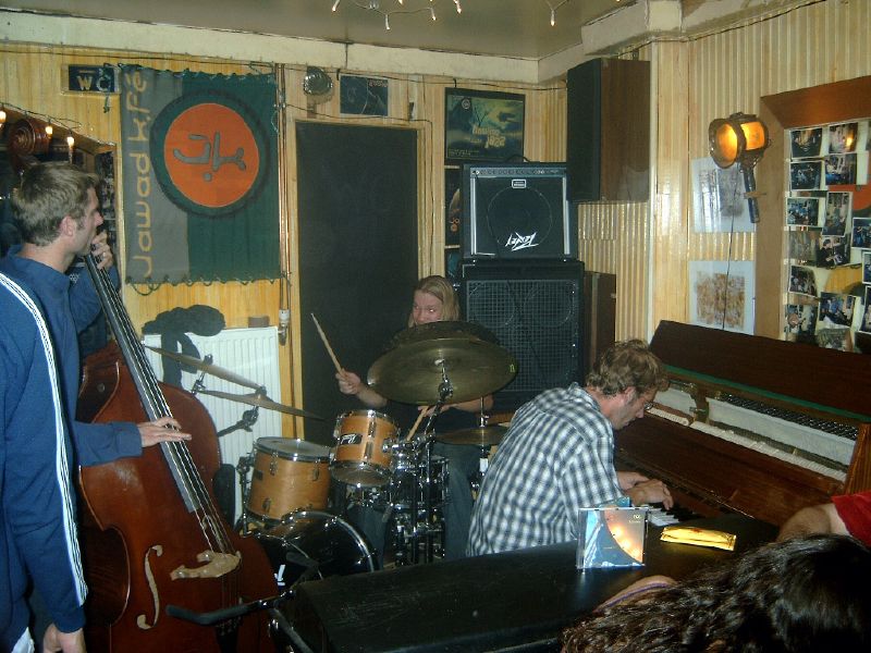 a group of young men are playing instruments in a room