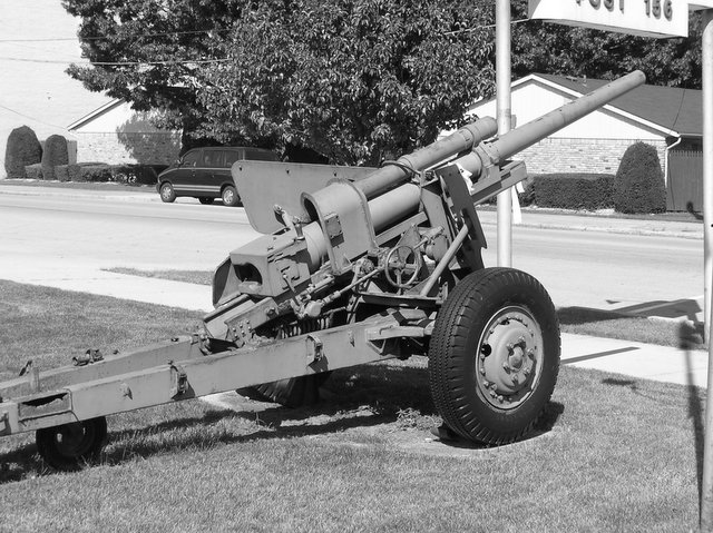 a big wooden gun on top of a tow truck