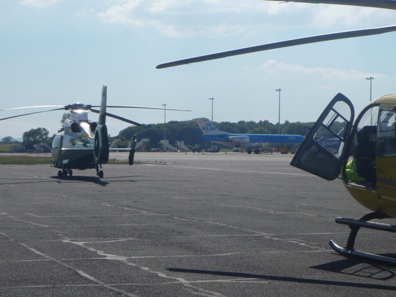 two helicopters that are in a parking lot
