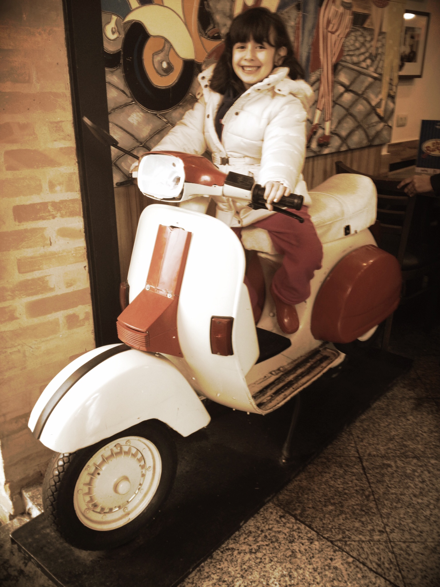 a young lady is riding a scooter on display