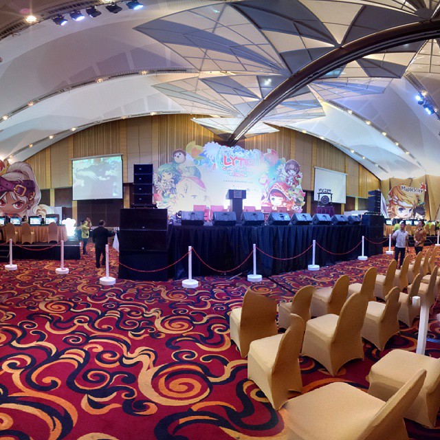 a banquet hall set up with chairs and podiums in front of an event