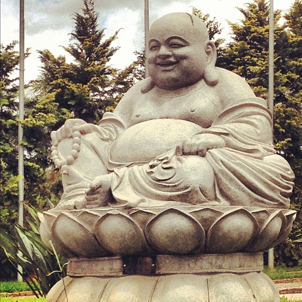 a statue of a buddha sitting inside a bowl