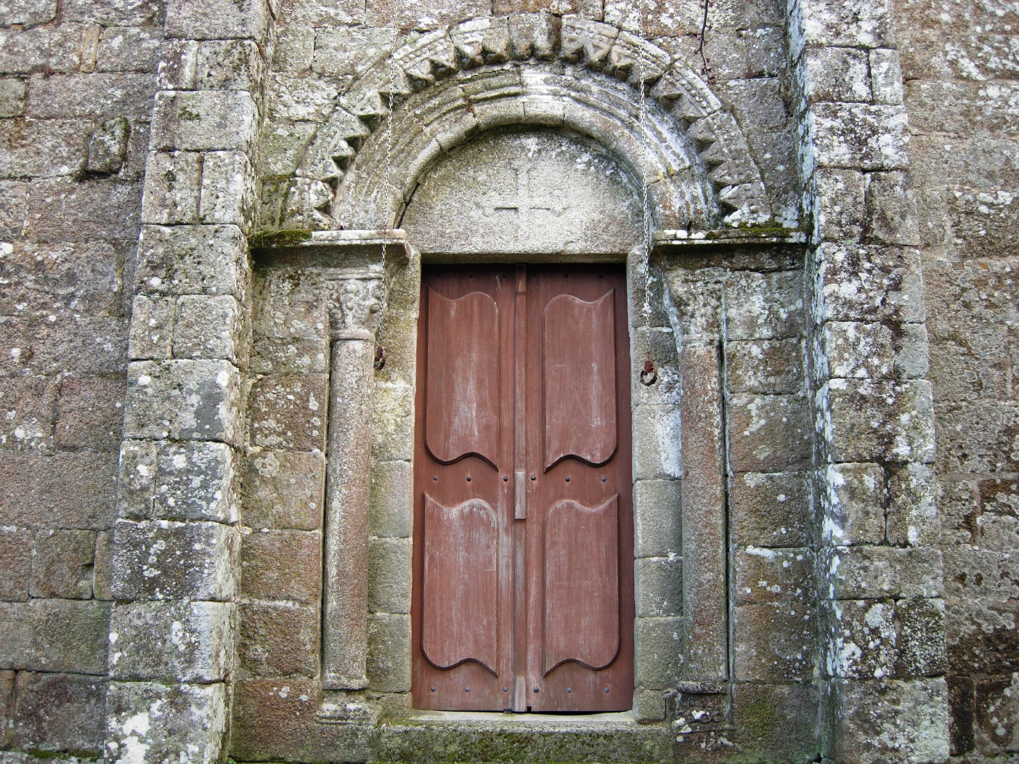 a door with two double doors that are on top of stone