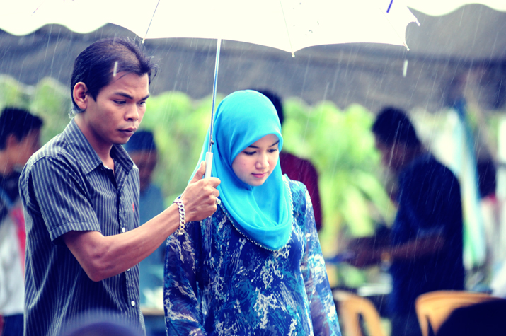 a man holding an umbrella near a woman