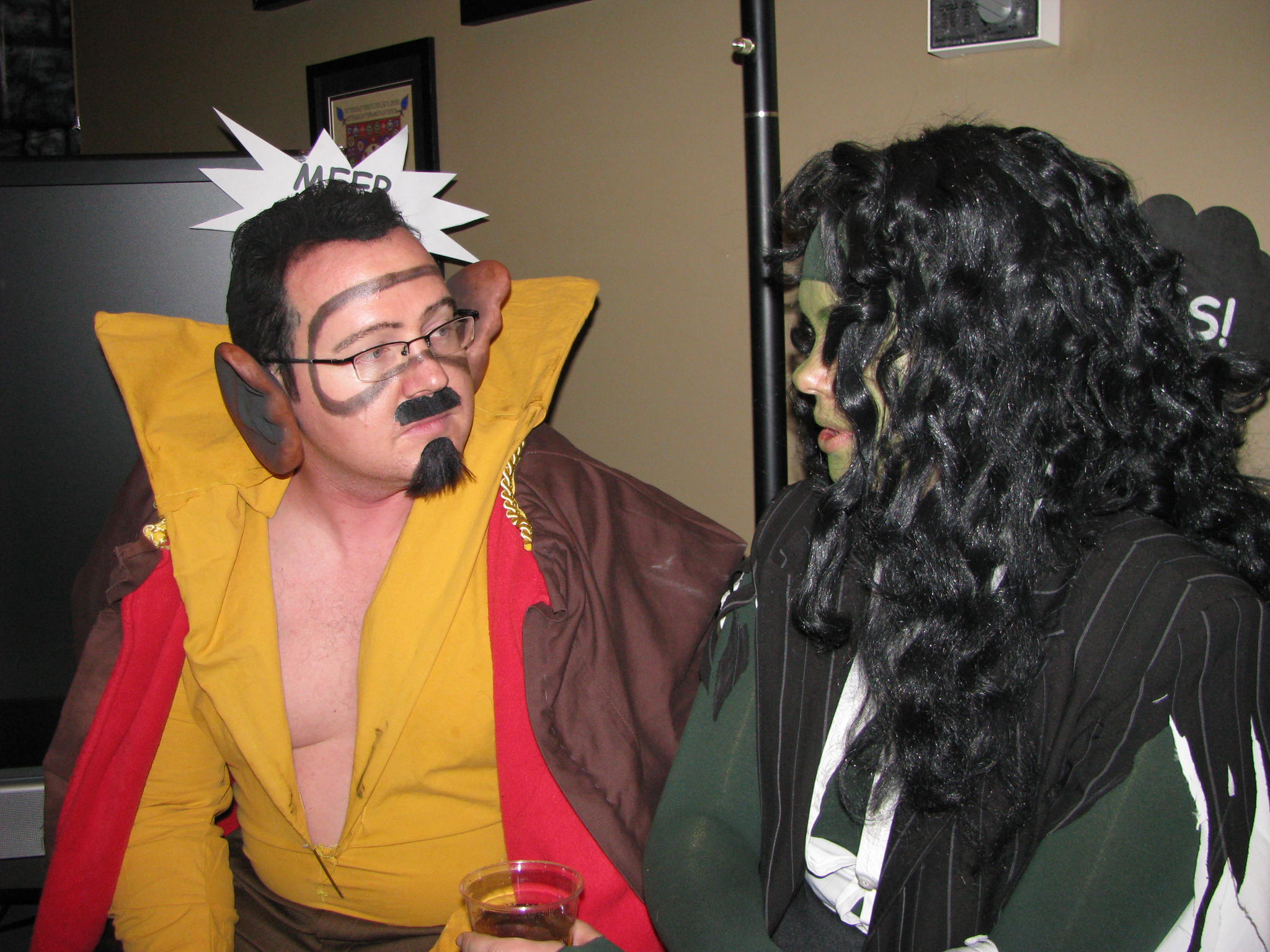 two people are dressed as goofy and a man with weird clothes