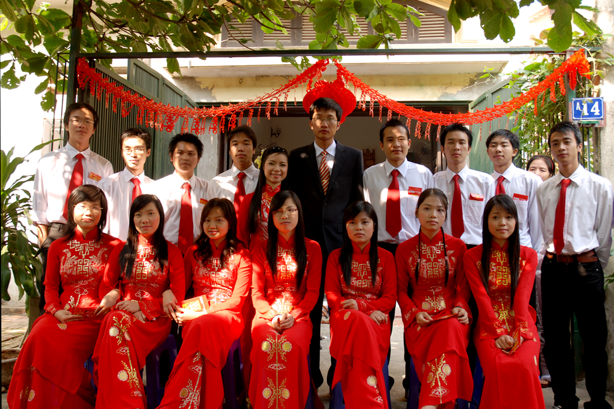 the group of people in formal attire poses for a picture