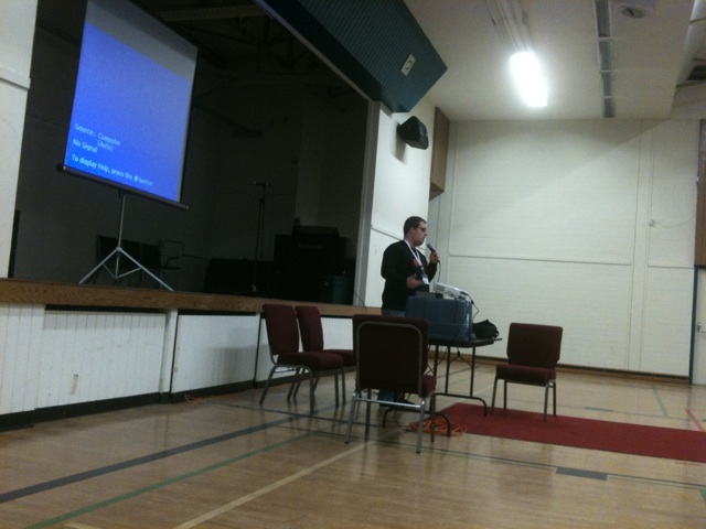 man standing in front of a projection screen