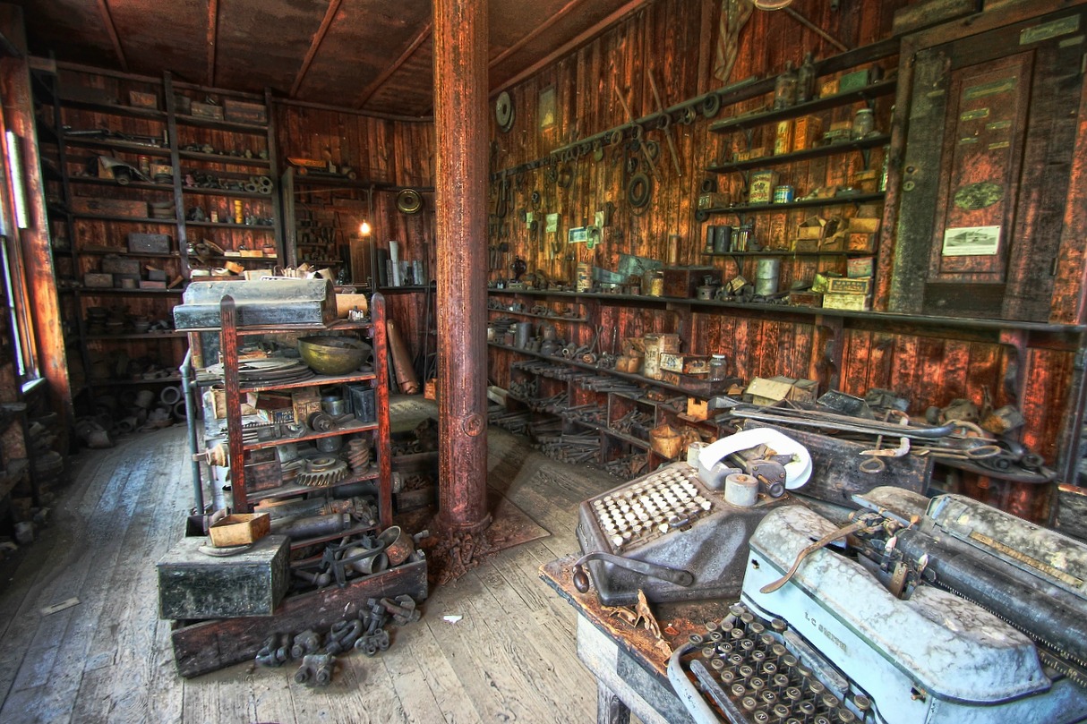 an old factory room has many shelves full of typewriters