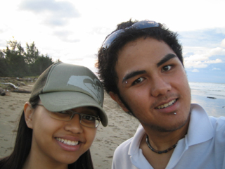 a close up of two people near the ocean