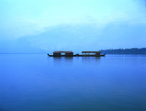 three canoes docked on a calm body of water