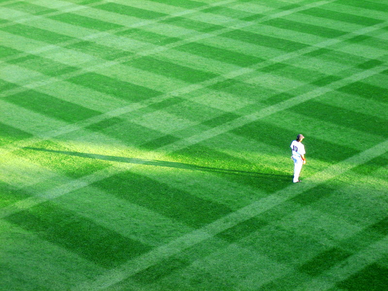 a baseball player in white on the field