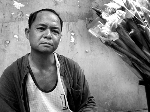 a man is standing with some flowers