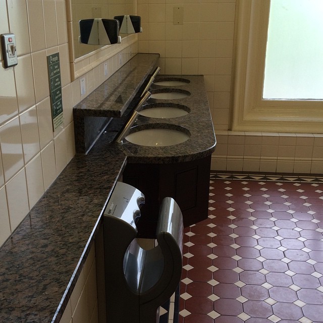a bathroom with two sinks and other bathroom amenities