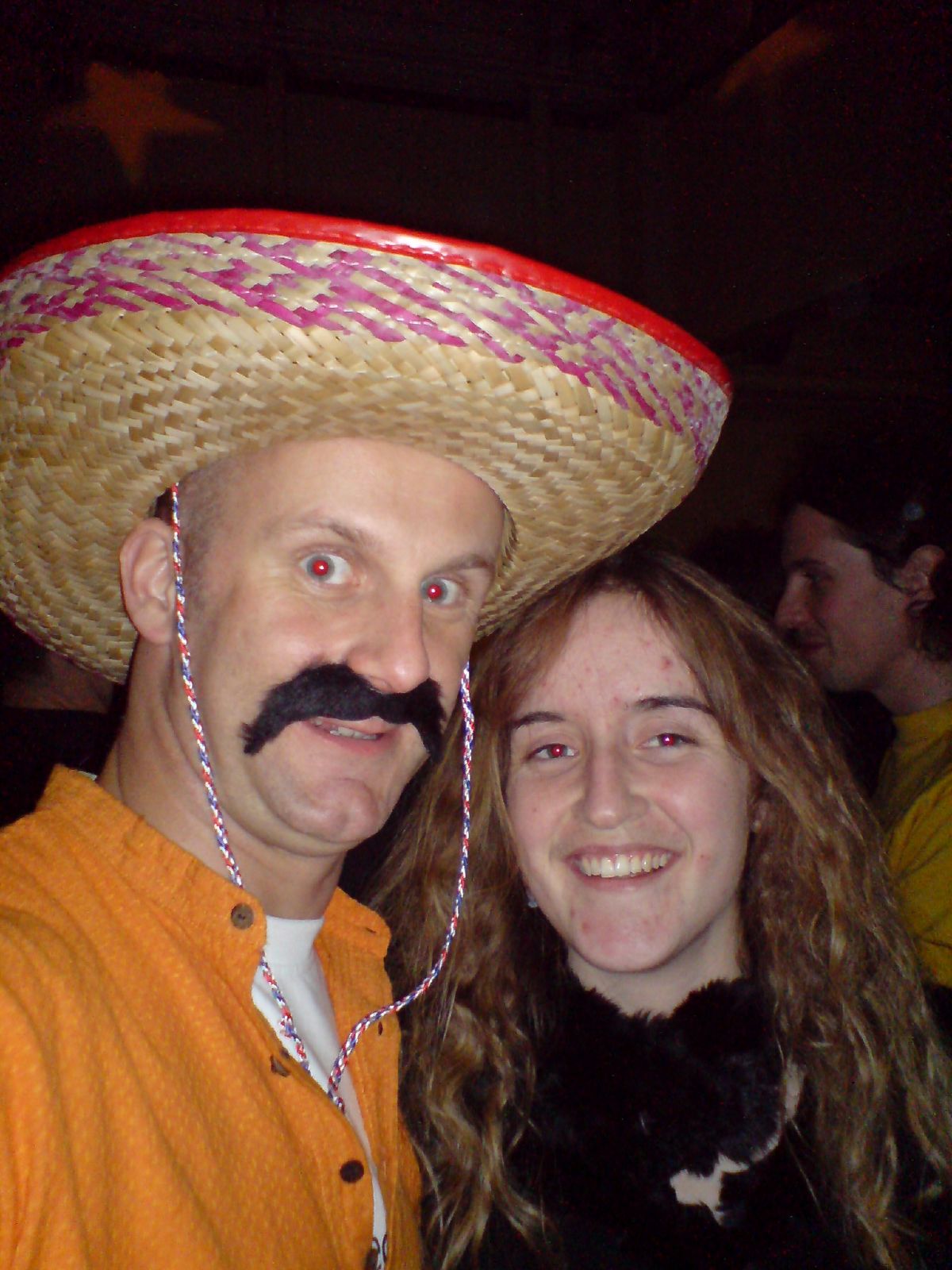 a man with a mustache wearing a straw hat