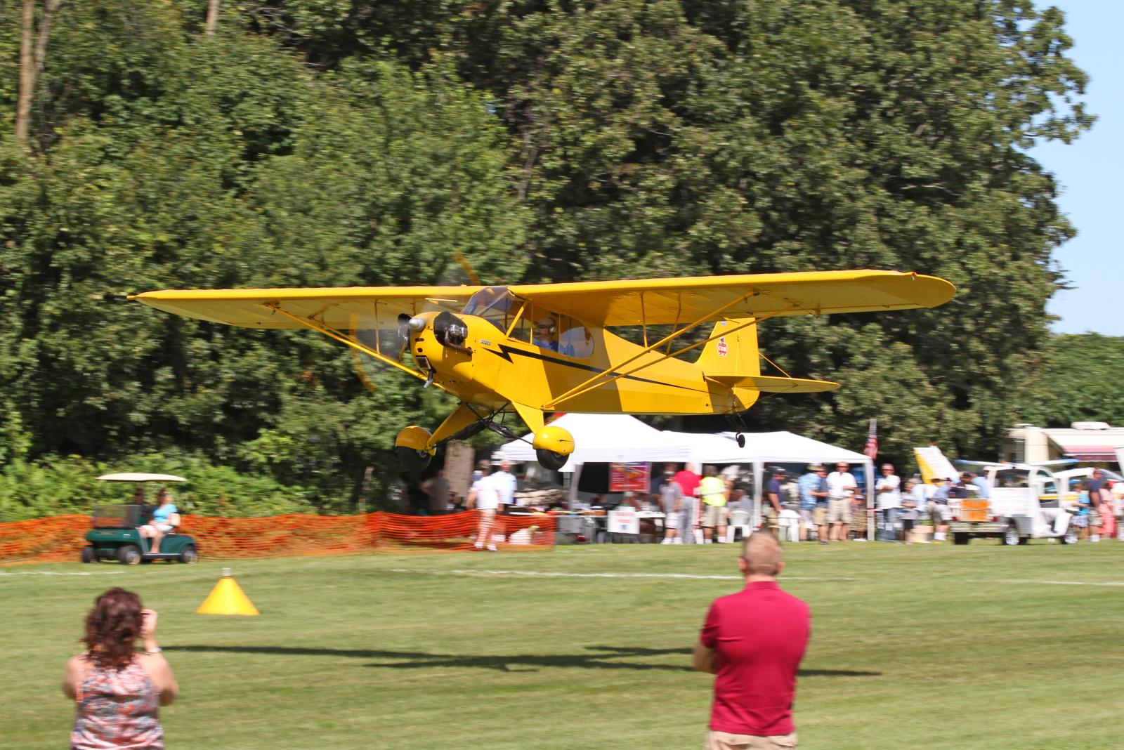 people looking at an air plane in the air