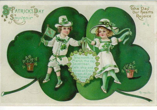 two little girls holding hands in front of a green heart