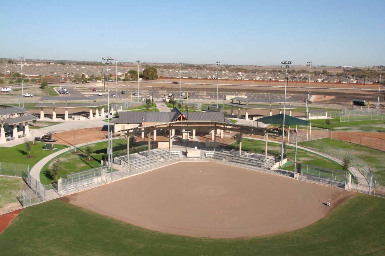 a baseball diamond in a baseball field that has a fence on it