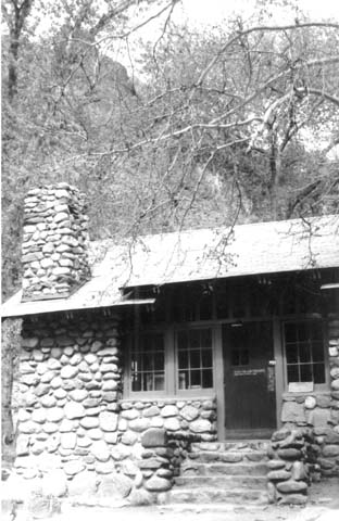 the front facade of a small log cabin