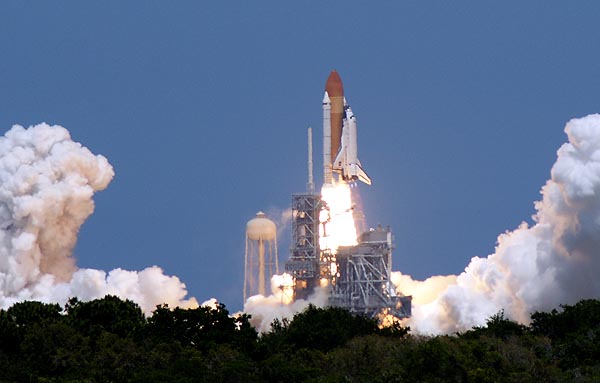 a space shuttle lifting off from the launch pad