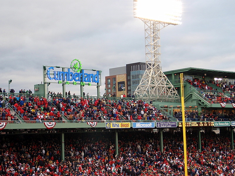 a stadium filled with people and big green stands