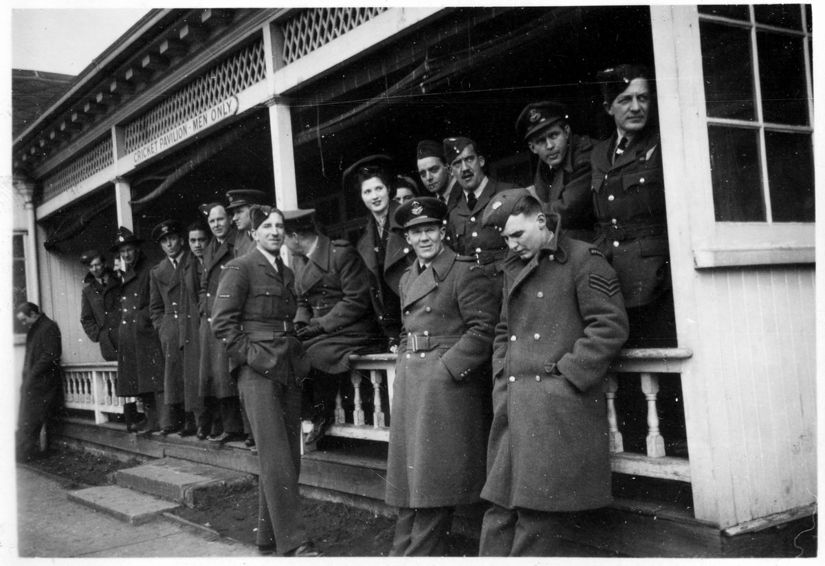 a group of women dressed in military uniforms are outside of a building