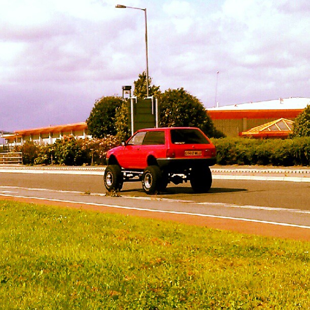 a bright red pickup truck driving down the road