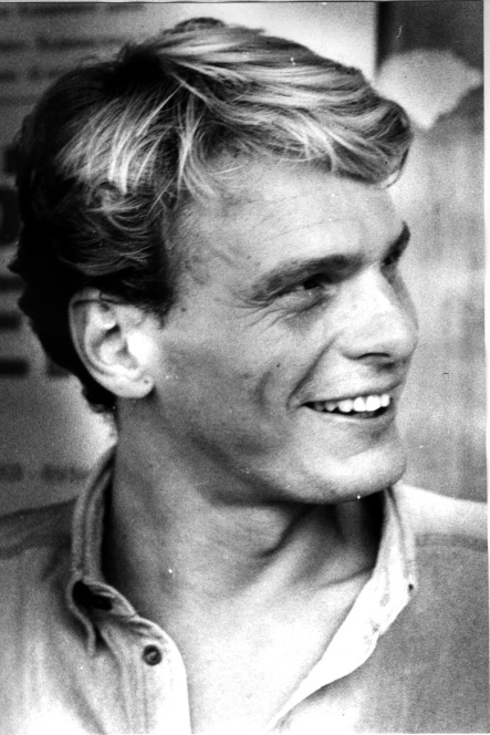 black and white pograph of man smiling with blonde hair