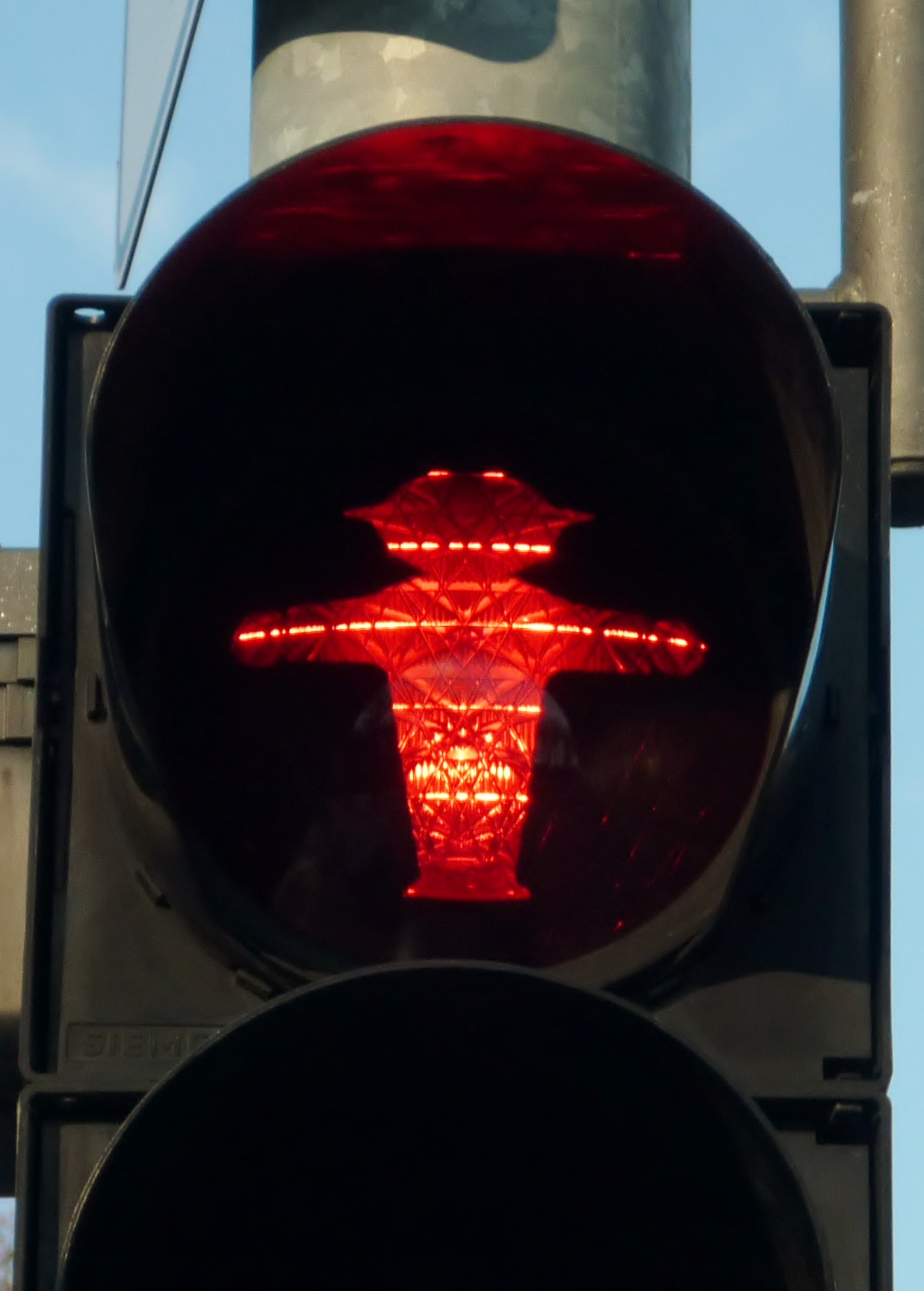a traffic light with a red cross on it