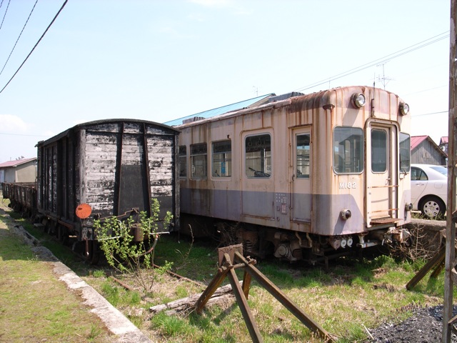 an old train car sitting on the tracks