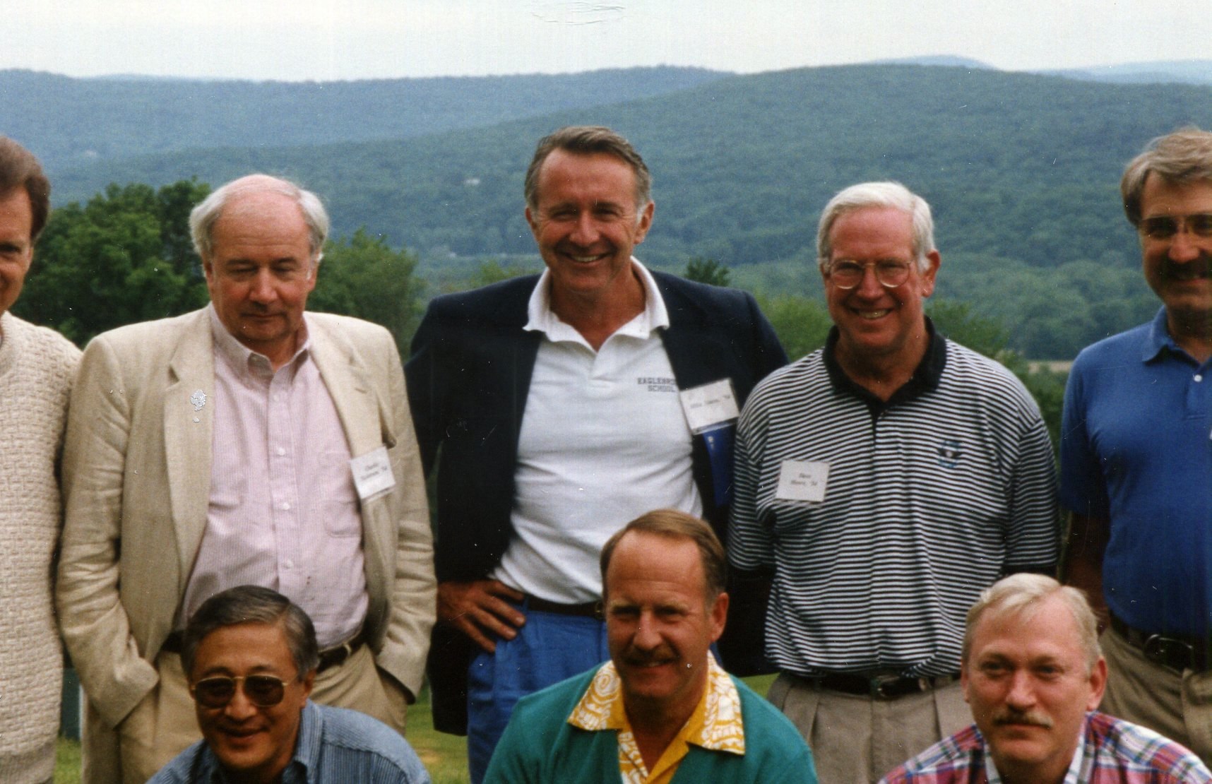 a group of men standing next to each other on a field