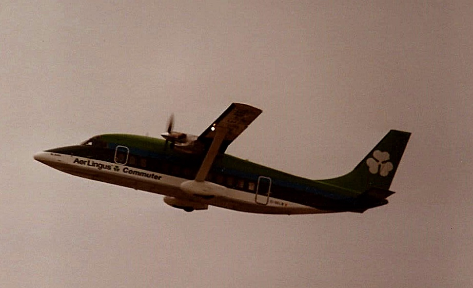 a small plane flying through the sky, during the day