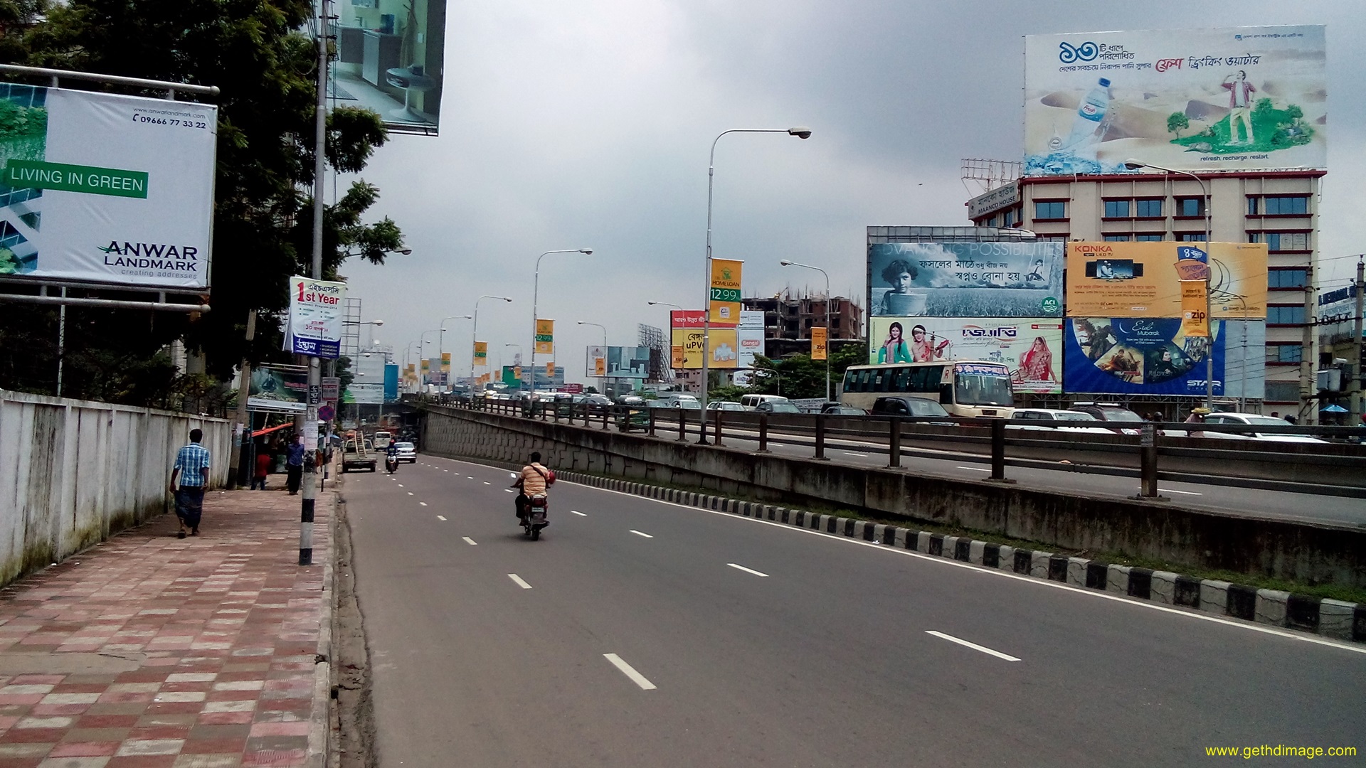 a group of people riding motorcycles down a highway