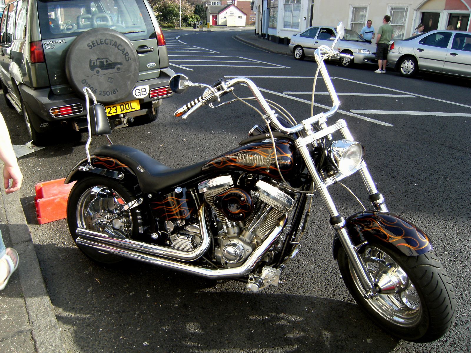 a motorcycle parked on the side of a road next to a building