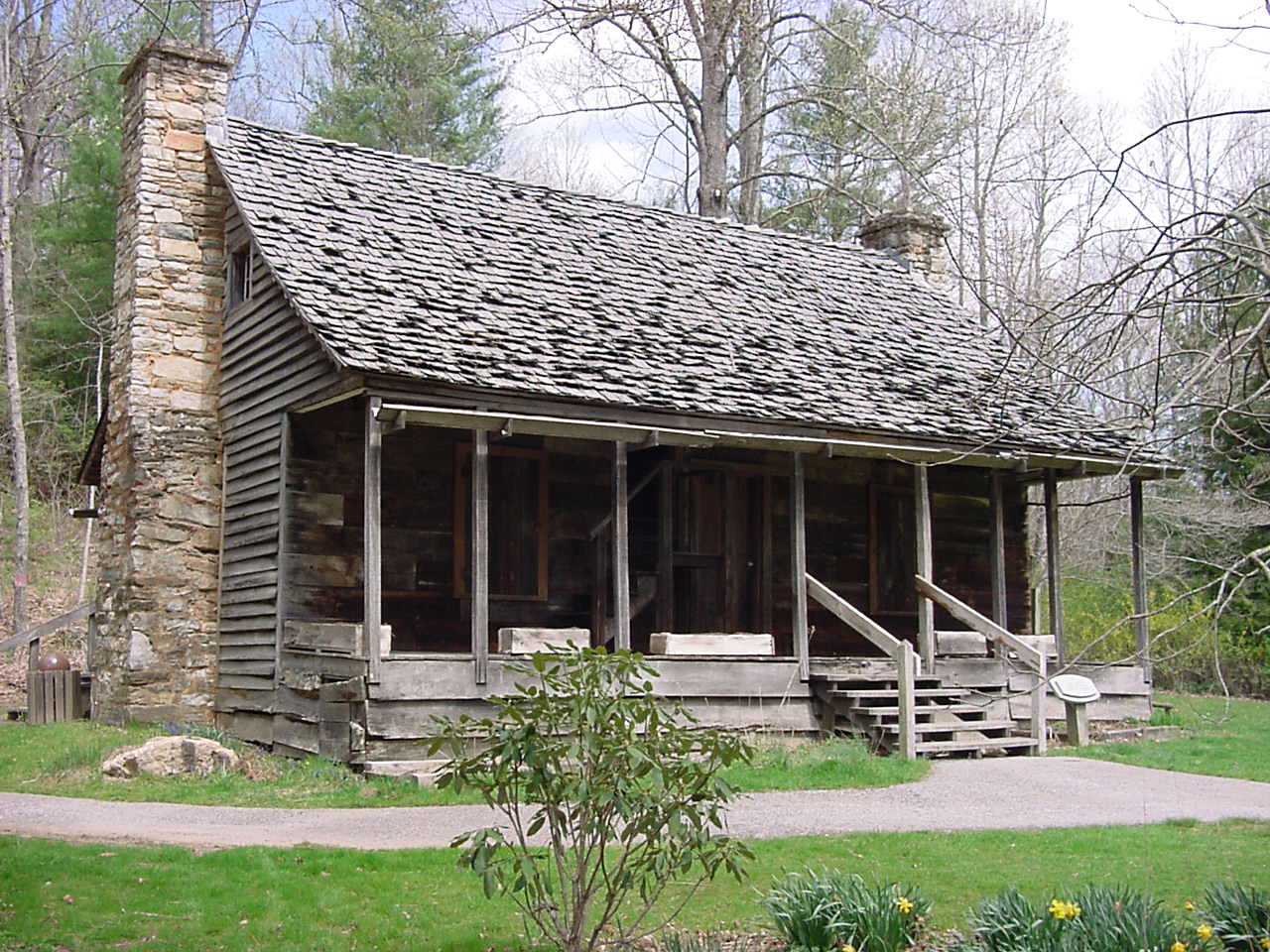 this is an old log cabin in a wooded area