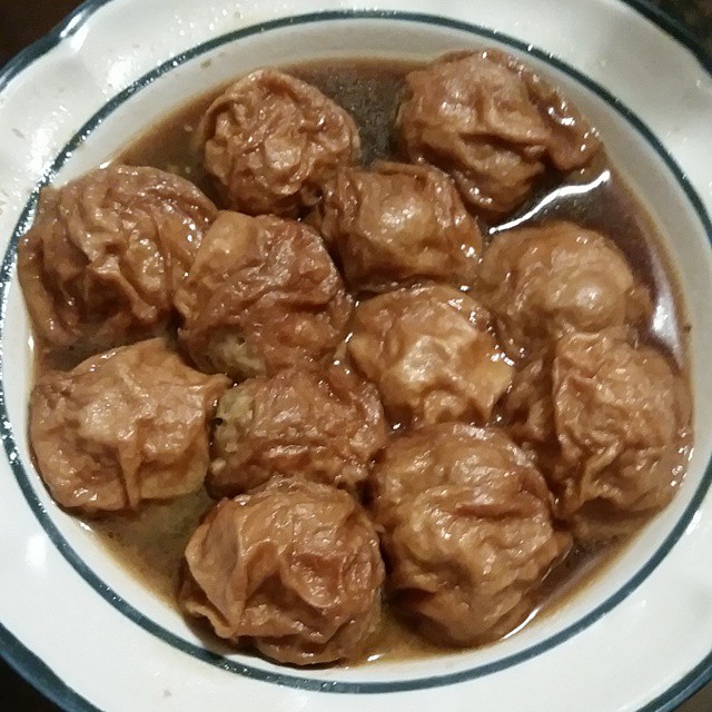 a white bowl filled with some meatballs in sauce