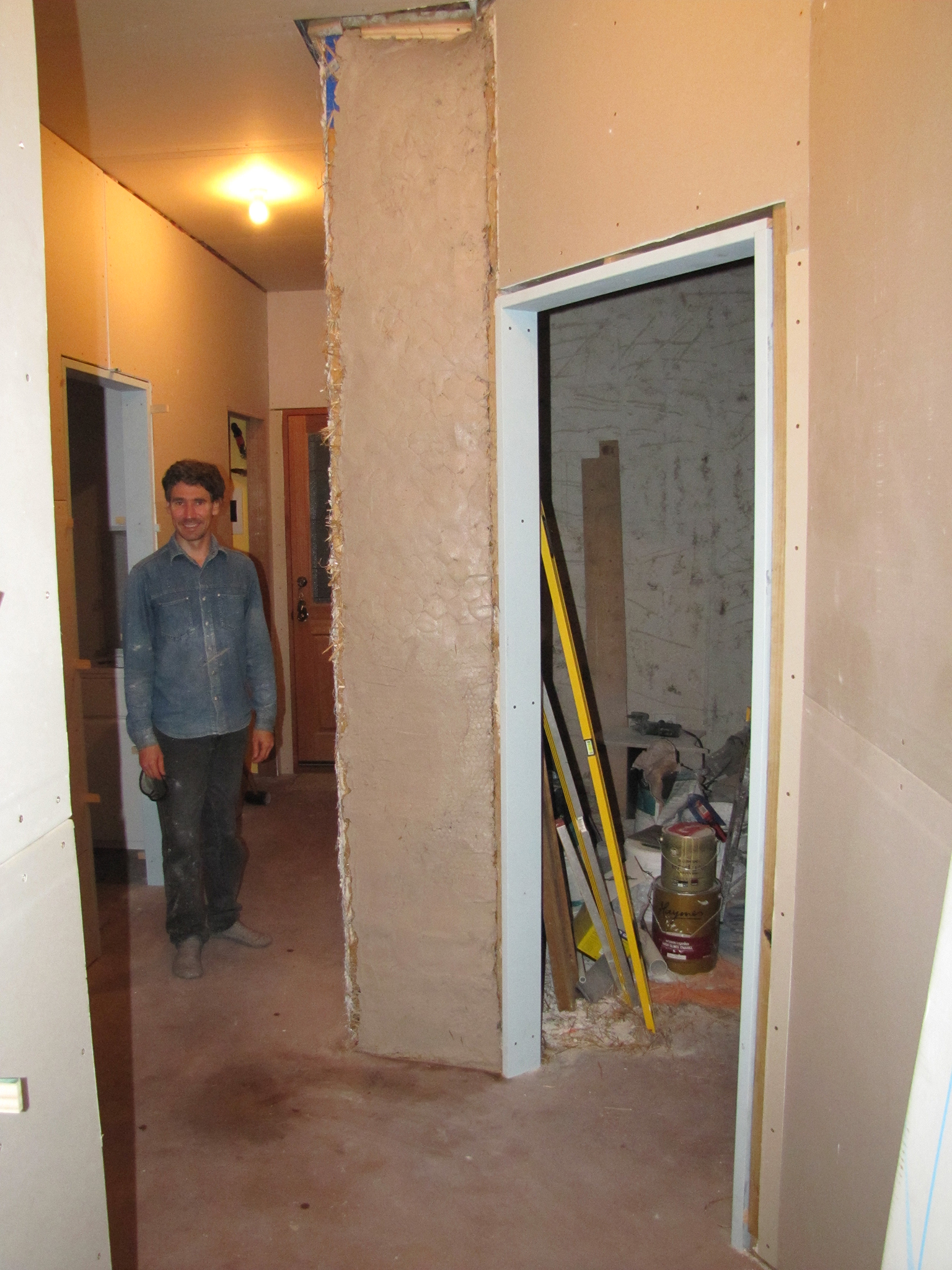 a man is standing inside of an unfinished house