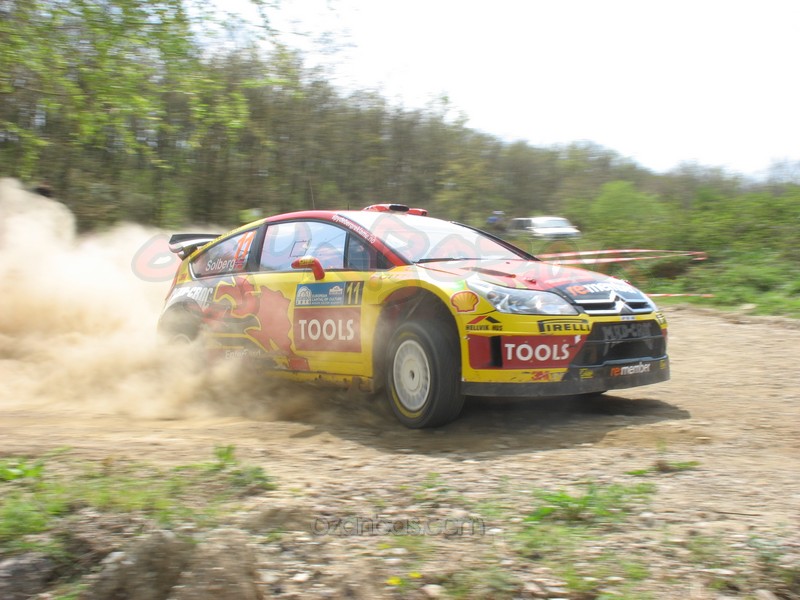 a racing car in action on a dirt road