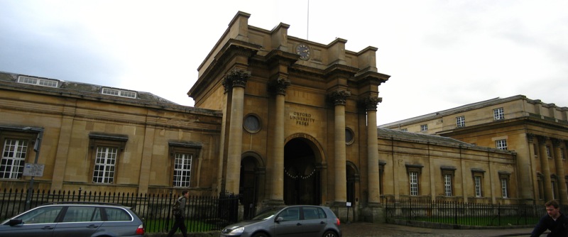 an image of a old building with cars in front of it