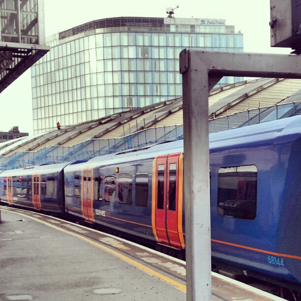 a blue and red train is at the station