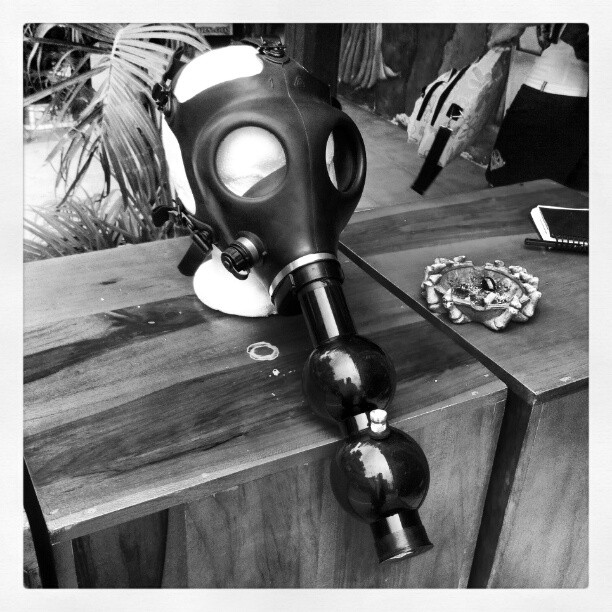 a gas mask on a table next to an ipod