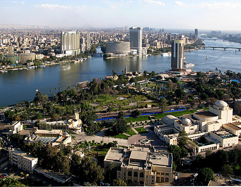 a wide city area with buildings along the river