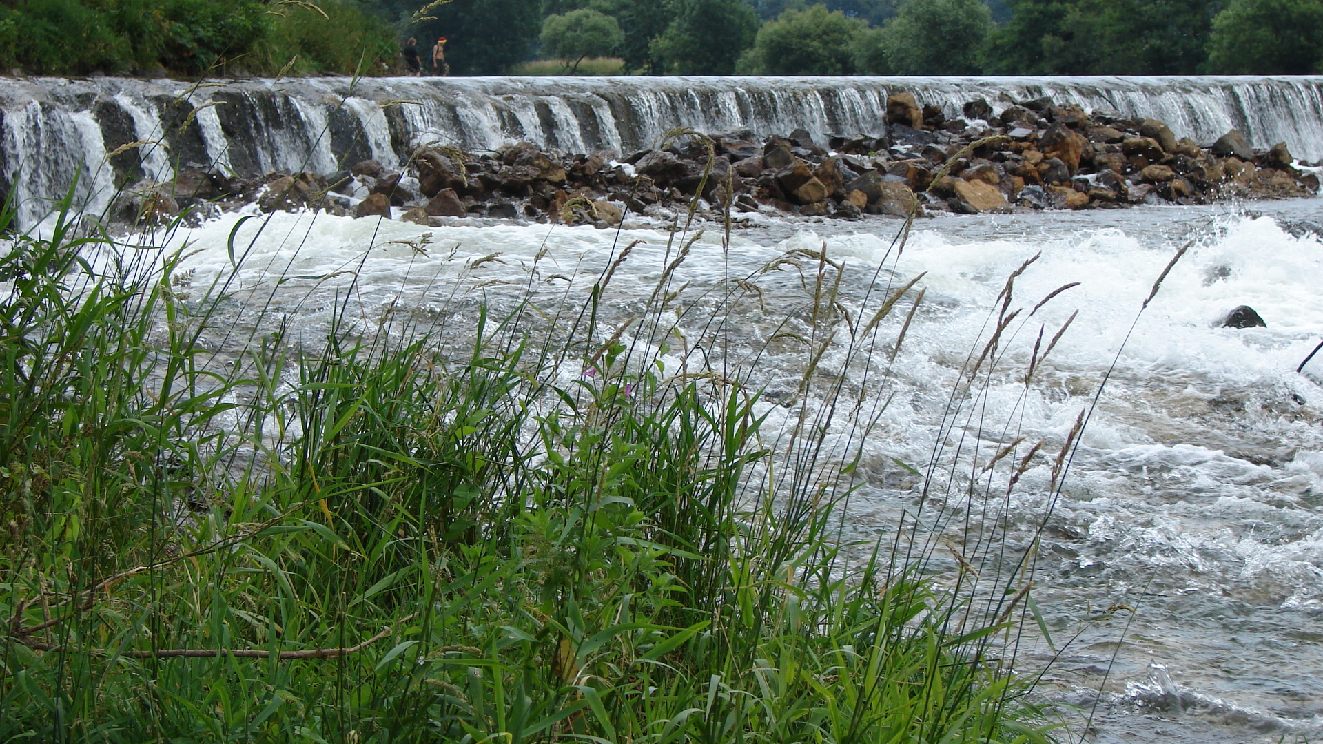 a river with lots of water near many rocks