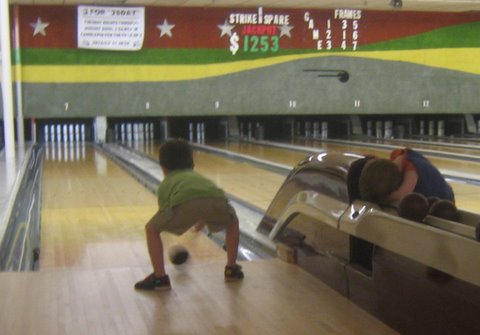 a bowling alley filled with people playing bowling