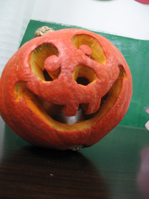 an adorable pumpkin decorated with an interesting face