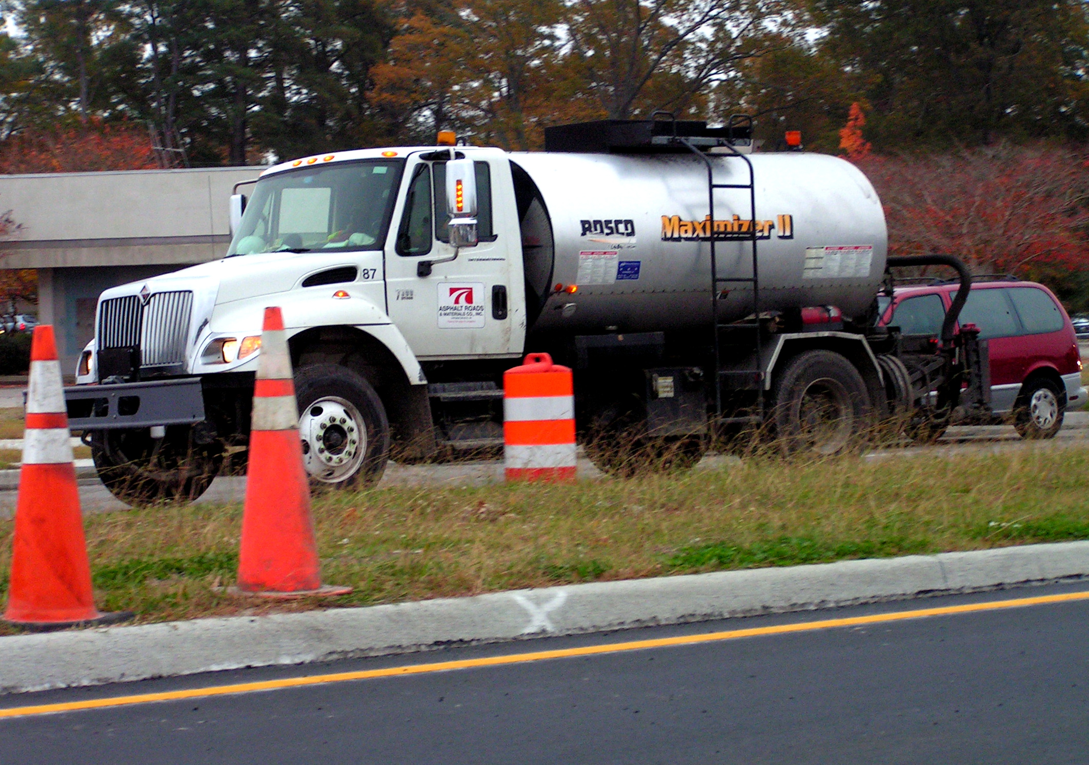 a cement mixer parked by road cones