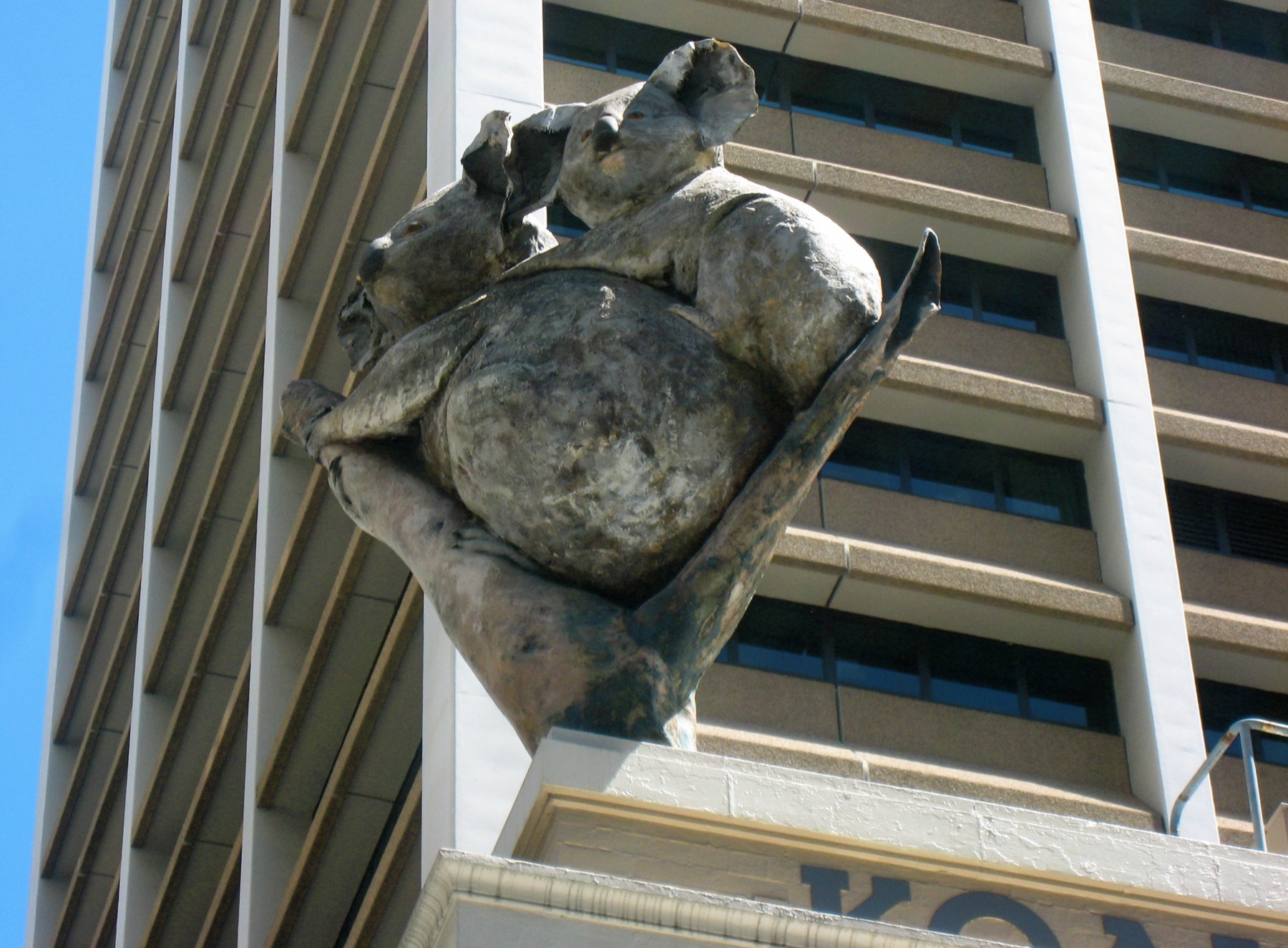 a statue is shown in front of a tall building